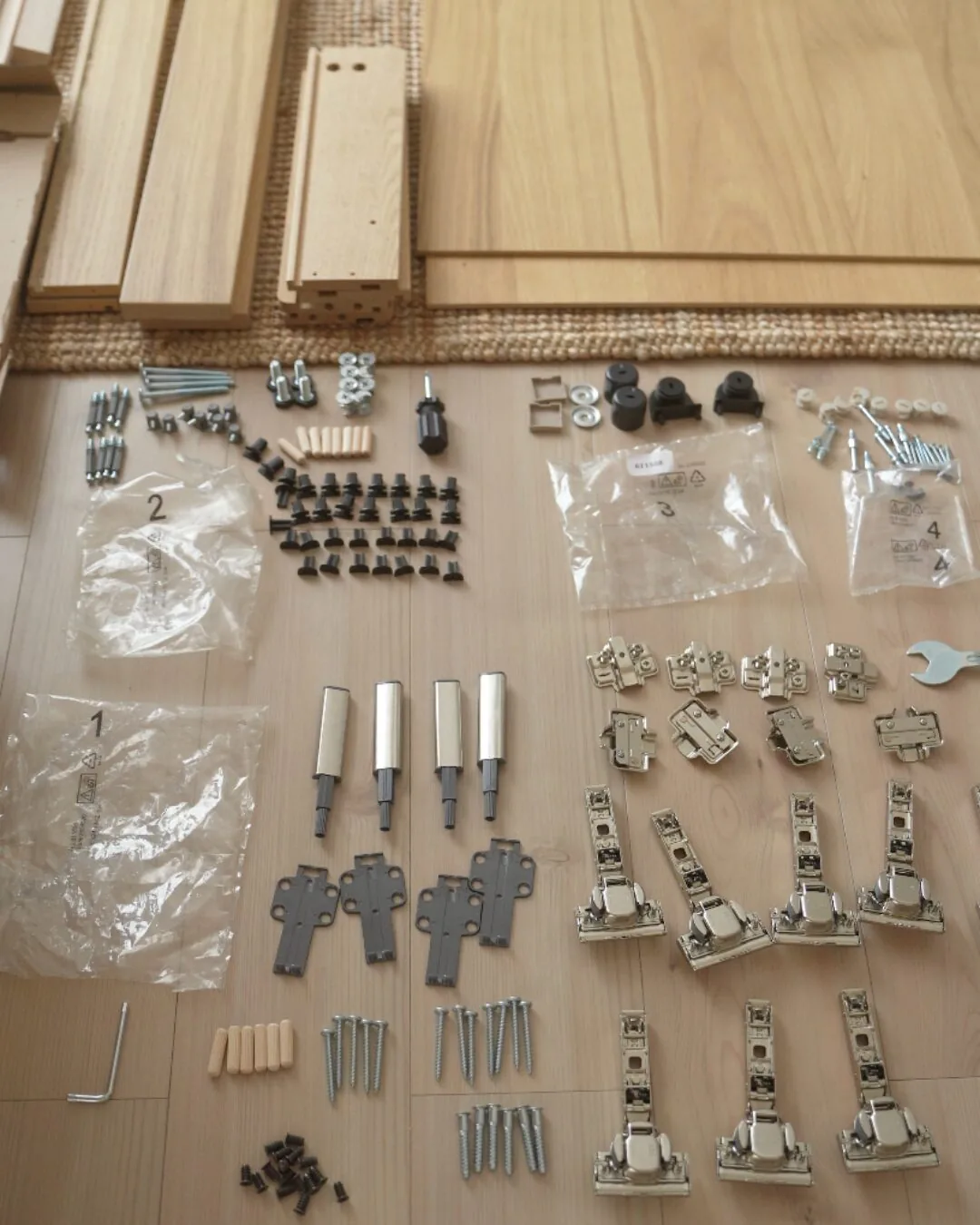 床に並べた組み立て用の金具・ネジ・工具一式